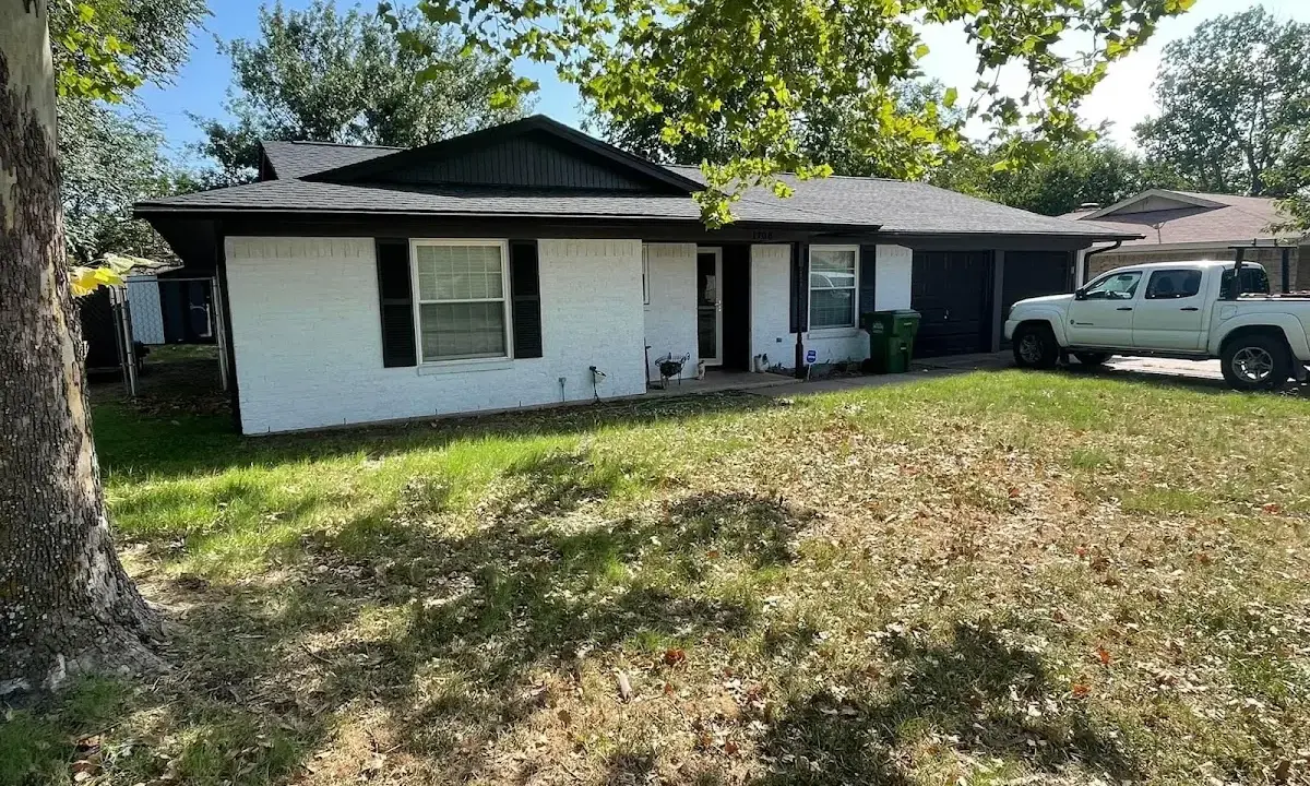 Professional roofing crew working on a residential roof in Statesville